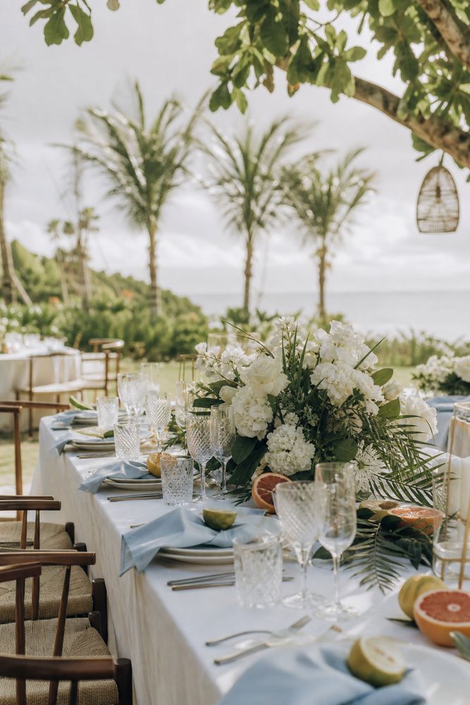 Table set for an intimate milestone celebration, candlelight and garden greenery in the evening