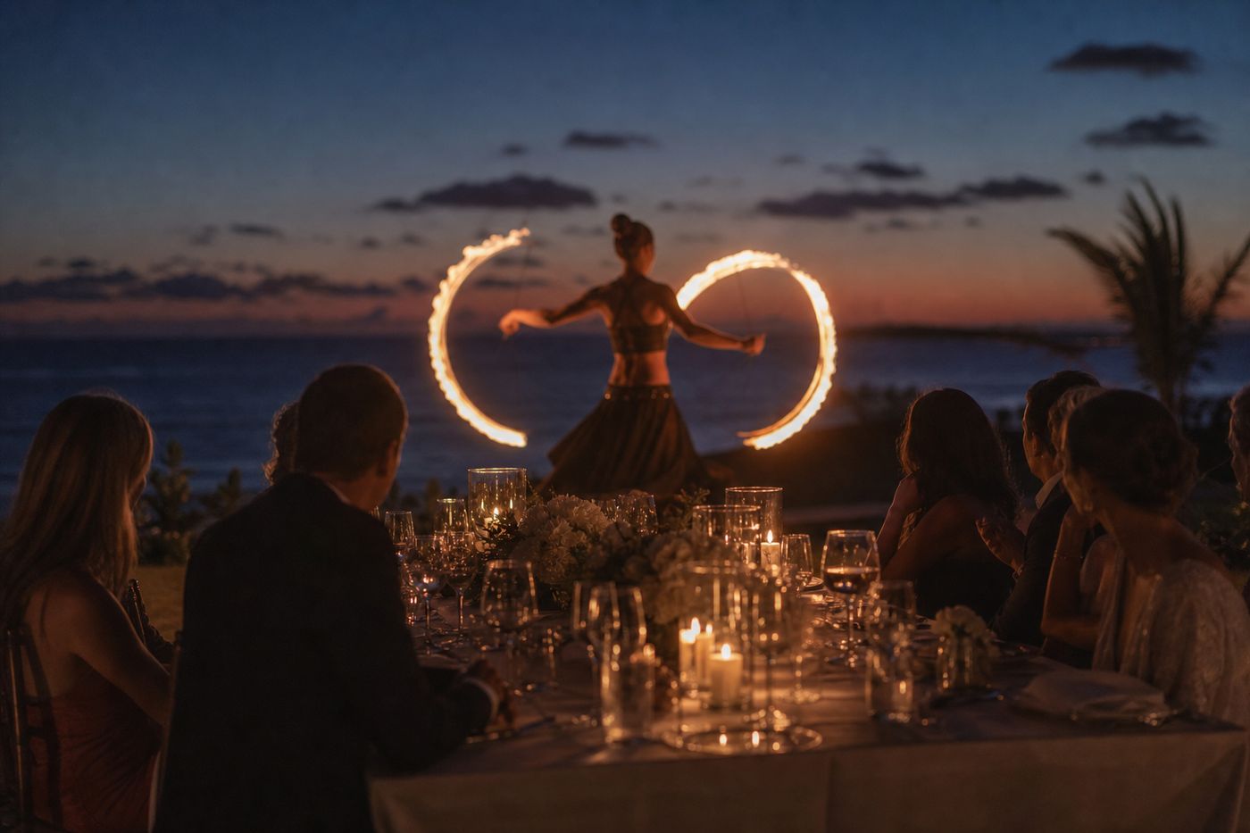 Fire performer at dusk closing an evening celebration, Ko Olina