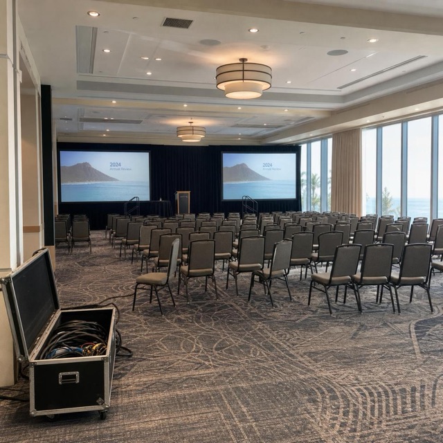 Conference room set beside ocean-facing windows in Honolulu